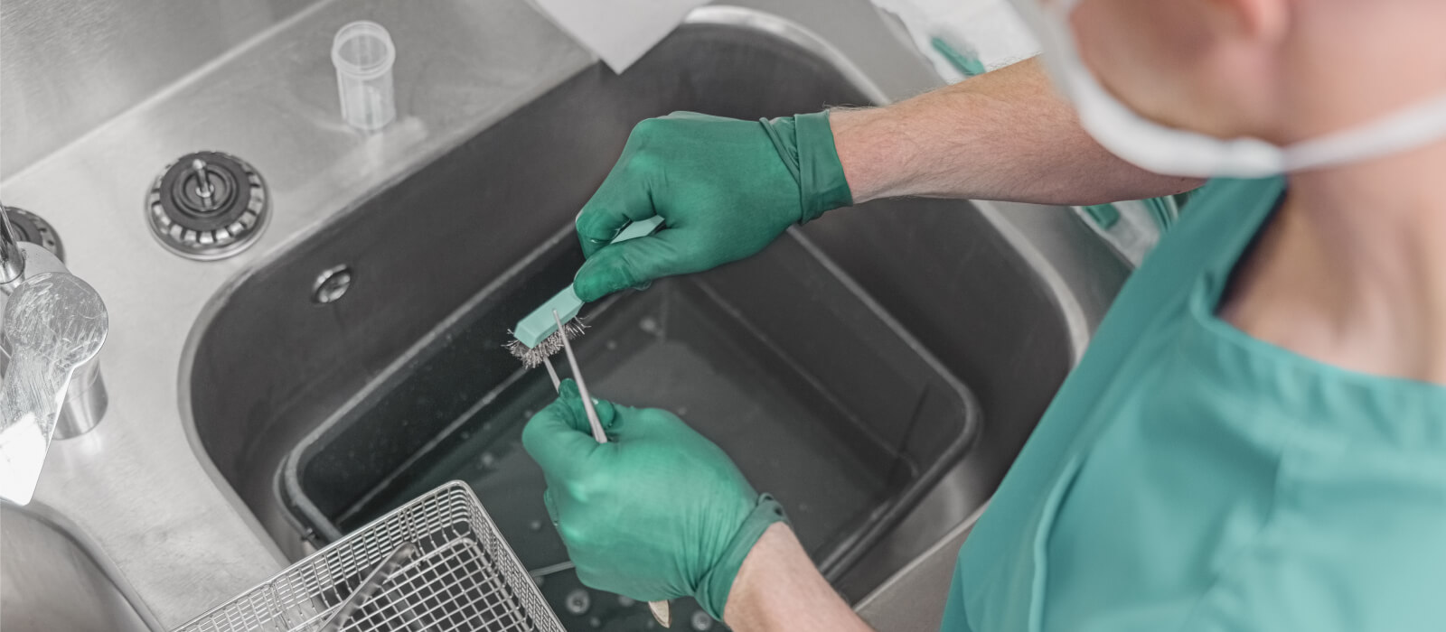 Nurse washing medical instruments after operation